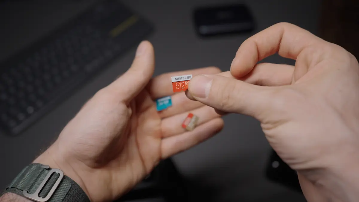 Hands holding a microSD card.