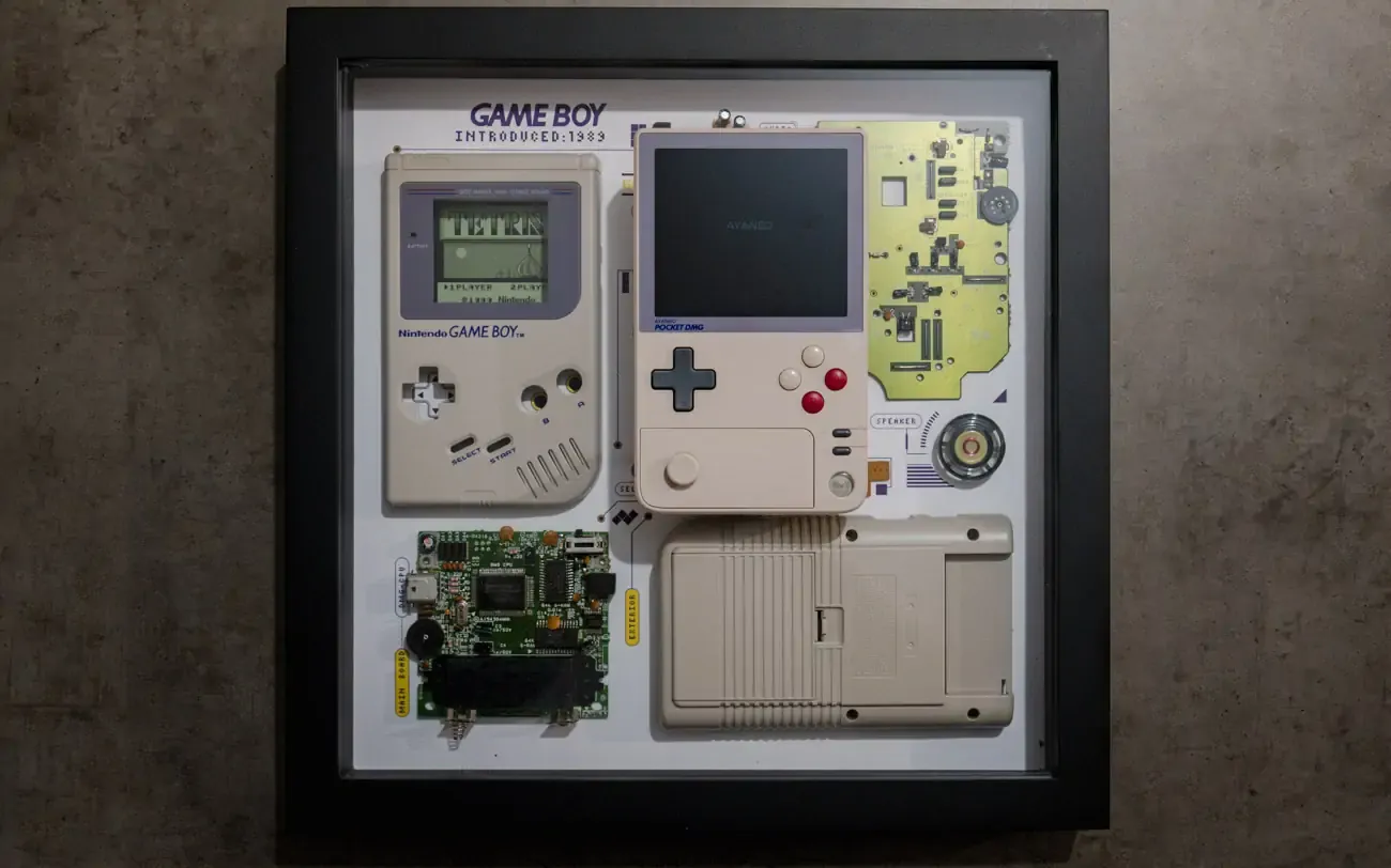 AYANEO Pocket DMG lying on Game Boy Grid Studio